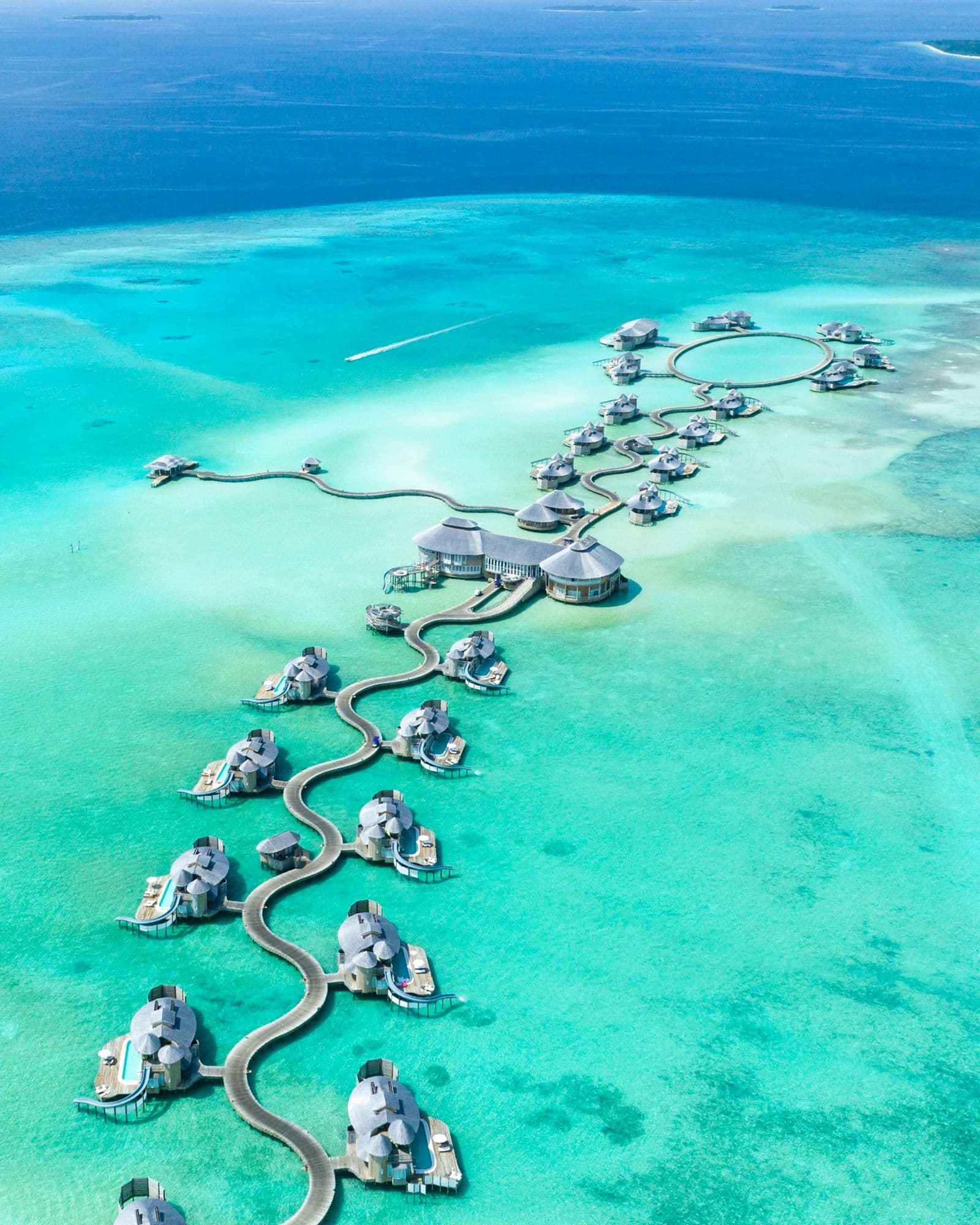 Overwater villas in a turquoise lagoon, Maldives